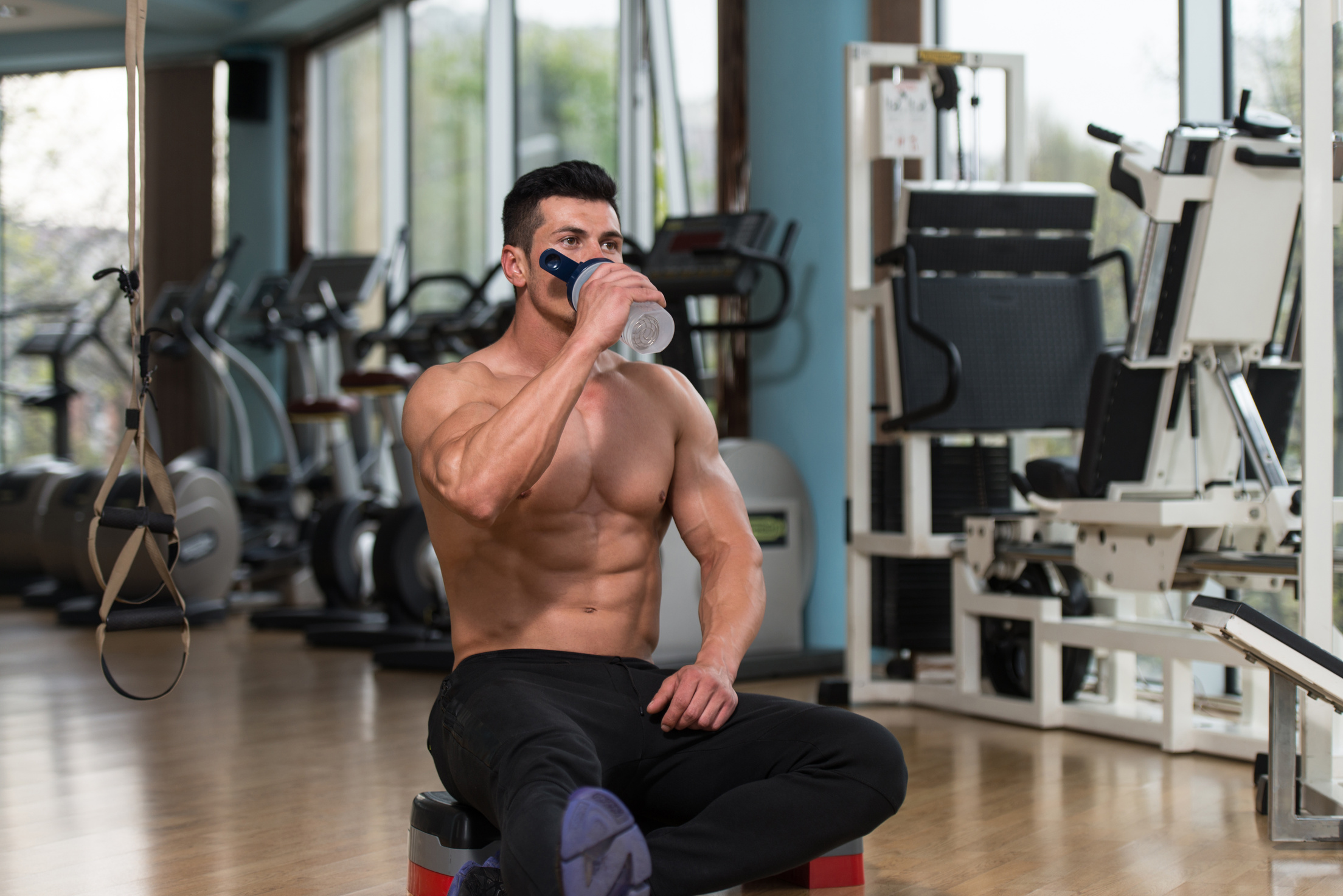 Body builder Drinking Water From Shaker